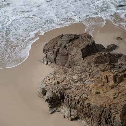 Vague s'échouant au pied d'un rocher
